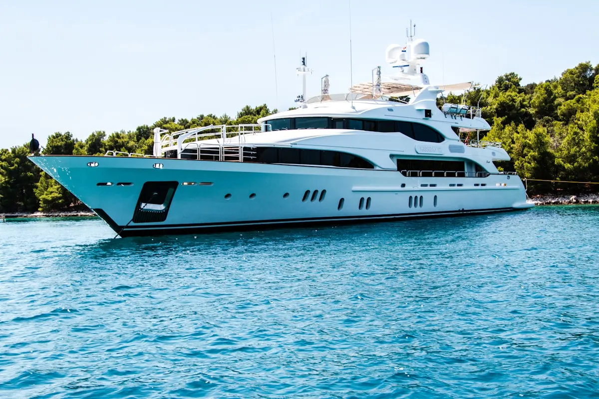 Motor vessel at anchor in clear coastal water